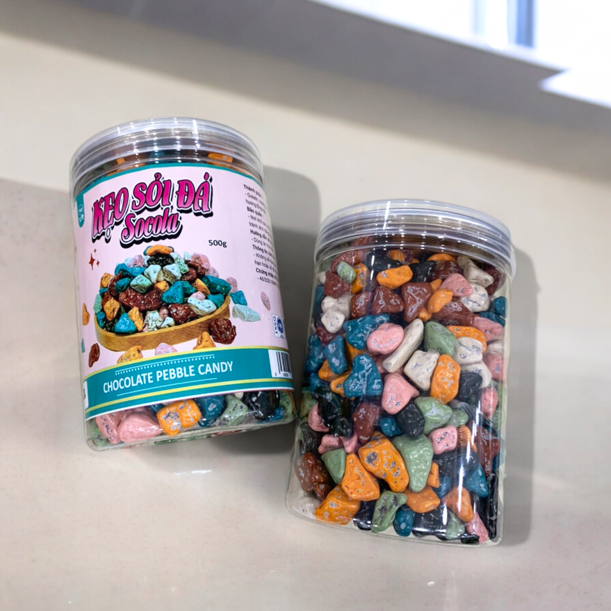 24452_z5494824046368-d2a3d29bd043ecbcaffc915f2d970e45-photoroom_20240601150022-1.png Kẹo Socola Sỏi Đá 500g - 8936208930424